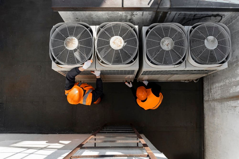 Air conditioning maintenance service being performed on an outdoor unit